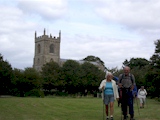 Our group leaving Addlethorpe Village Green with church in background.