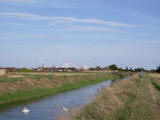 Looking east along drain bank towards the village of Ingoldmells and Fantasy Island theme park.